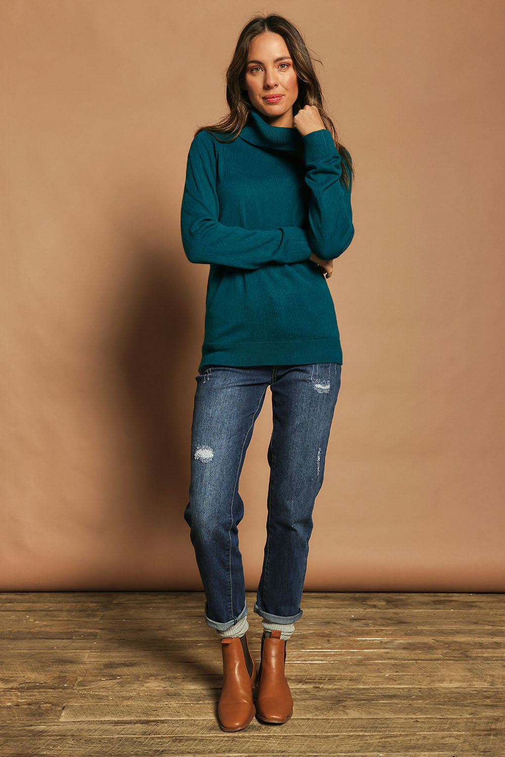 Model Madeline wearing size S of The Keepers Soft Roll Neck Jumper in colour Turquoise (Green), from the front, showing the whole outfit