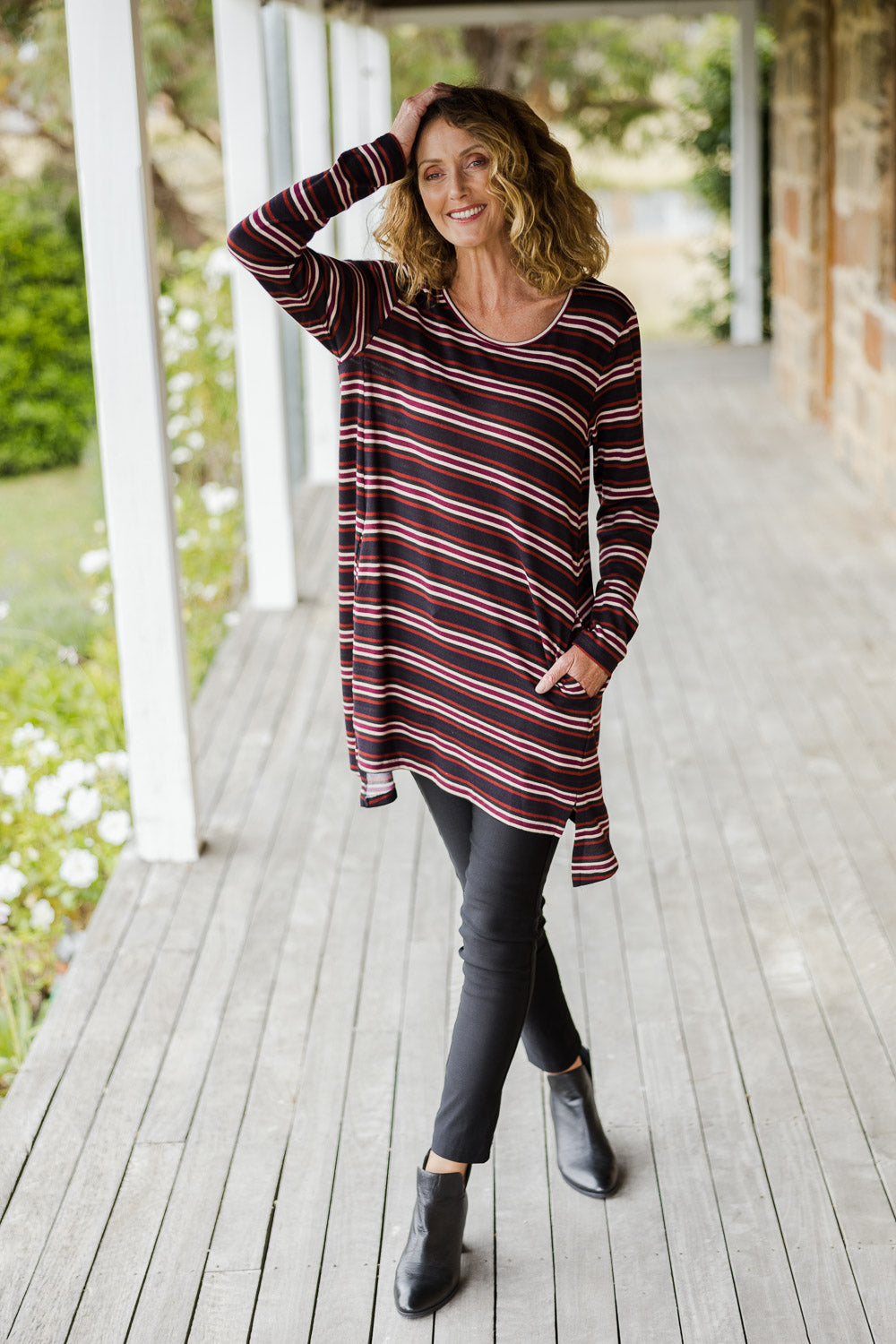 Model Emma wearing size 10 of The Striped Knit Crew Neck Tunic in colour Stripe (Blue), from the front, showing the whole outfit