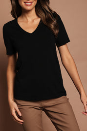 Model Madeline wearing size S of The Transeasonal Short Sleeve Jumper in colour Black (Black), from the front, cropped image