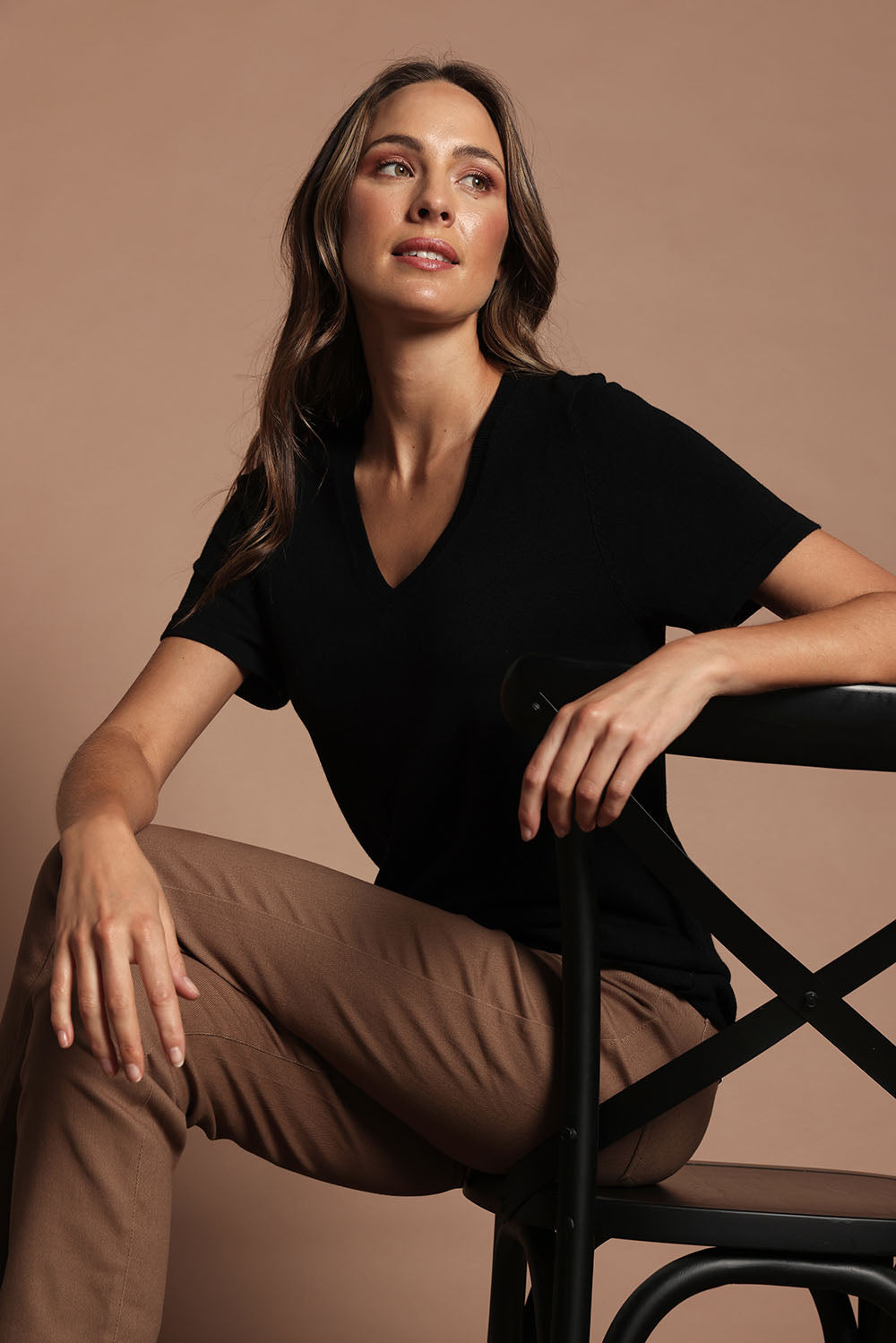 Model Madeline wearing size S of The Transeasonal Short Sleeve Jumper in colour Black (Black), from the front, showing the whole outfit