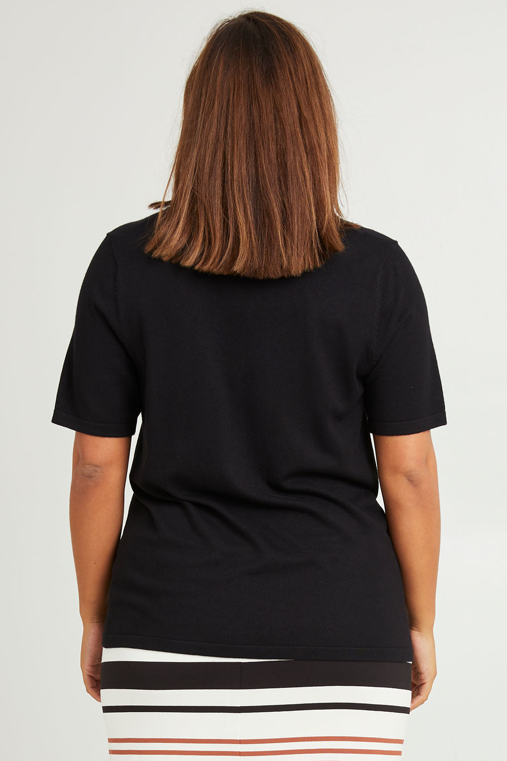 Model Monique wearing size L of The Transeasonal Short Sleeve Jumper in colour Black (Black), from the back