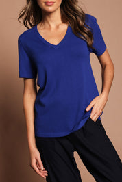 Model Madeline wearing size S of The Transeasonal Short Sleeve Jumper in colour Bluetopaz (Blue), from the front, cropped image