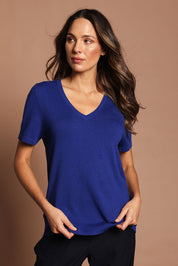 Model Madeline wearing size S of The Transeasonal Short Sleeve Jumper in colour Bluetopaz (Blue), from the front, showing the whole outfit