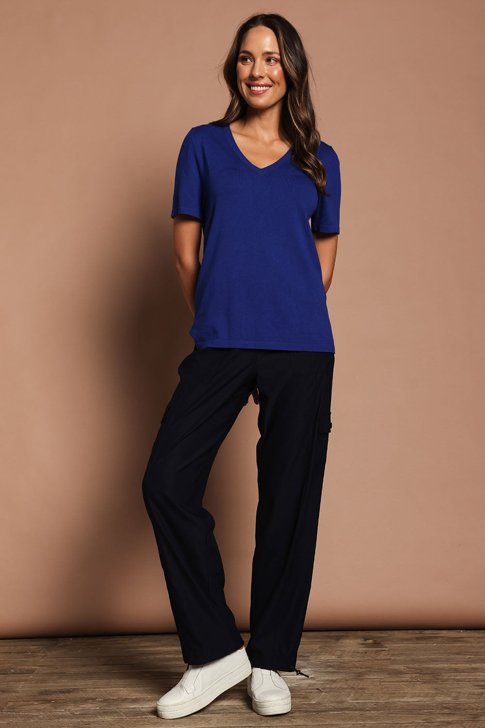 Model Madeline wearing size S of The Transeasonal Short Sleeve Jumper in colour Bluetopaz (Blue), from the front, showing the whole outfit