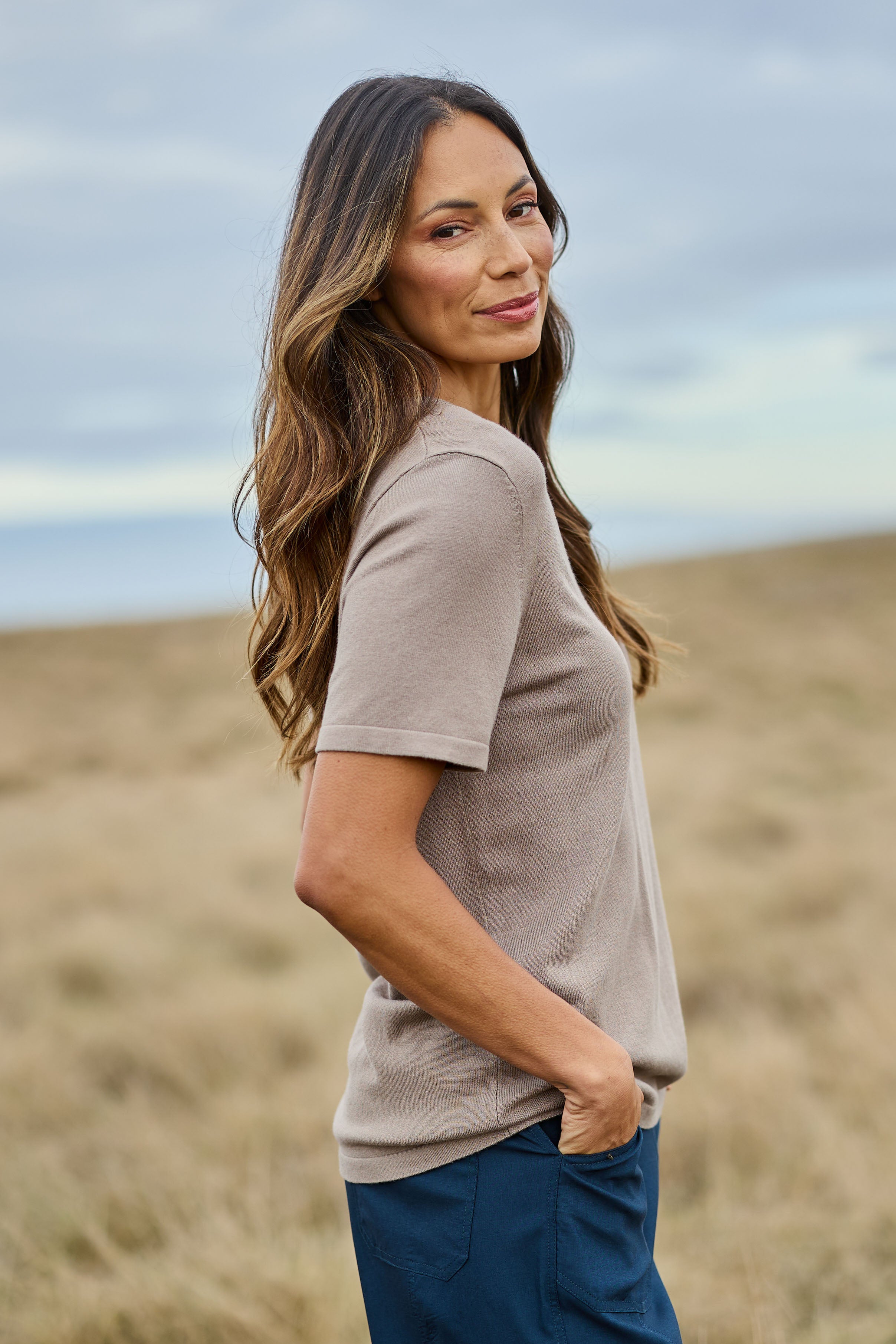 Model Amanda wearing size S of The Transeasonal Short Sleeve Jumper in colour Fawn, from the front, showing the whole outfit