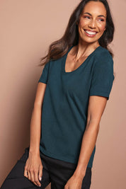 Model Amanda wearing size S of The Transeasonal Short Sleeve Jumper in colour Peacock (Green), from the front, cropped image