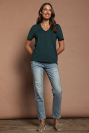 Model Madeline wearing size S of The Transeasonal Short Sleeve Jumper in colour Peacock (Green), from the front, showing the whole outfit