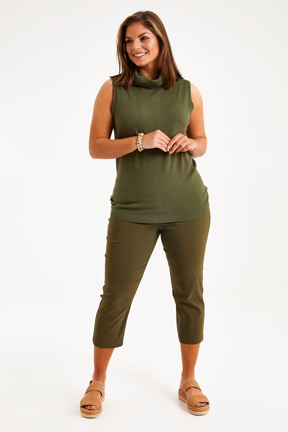 Model Monique wearing size 14 of The Contour Capri Pant in colour Olive (Green), from the front, showing the whole outfit