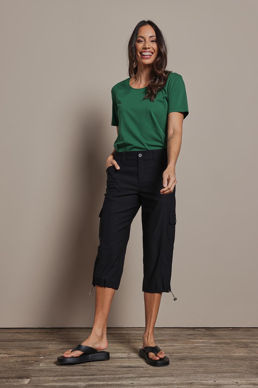 Model Amanda wearing size 10 of The Everyday Cropped Cargo Pant in colour Black (Black), from the front, showing the whole outfit