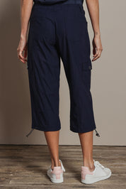 Model Amanda wearing size 10 of The Everyday Cropped Cargo Pant in colour Darknavy (Blue), from the back