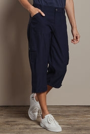 Model Amanda wearing size 10 of The Everyday Cropped Cargo Pant in colour Darknavy (Blue), from the front, cropped image