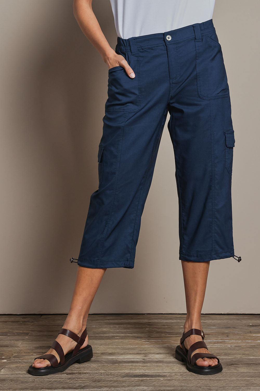 Model Amanda wearing size 10 of The Everyday Cropped Cargo Pant in colour Petrol (Blue), from the front, cropped image
