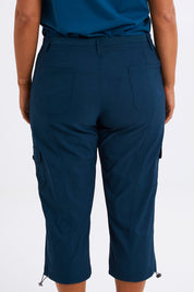 Model Monique wearing size 14 of The Everyday Cropped Cargo Pant in colour Petrol (Blue), from the front, cropped image