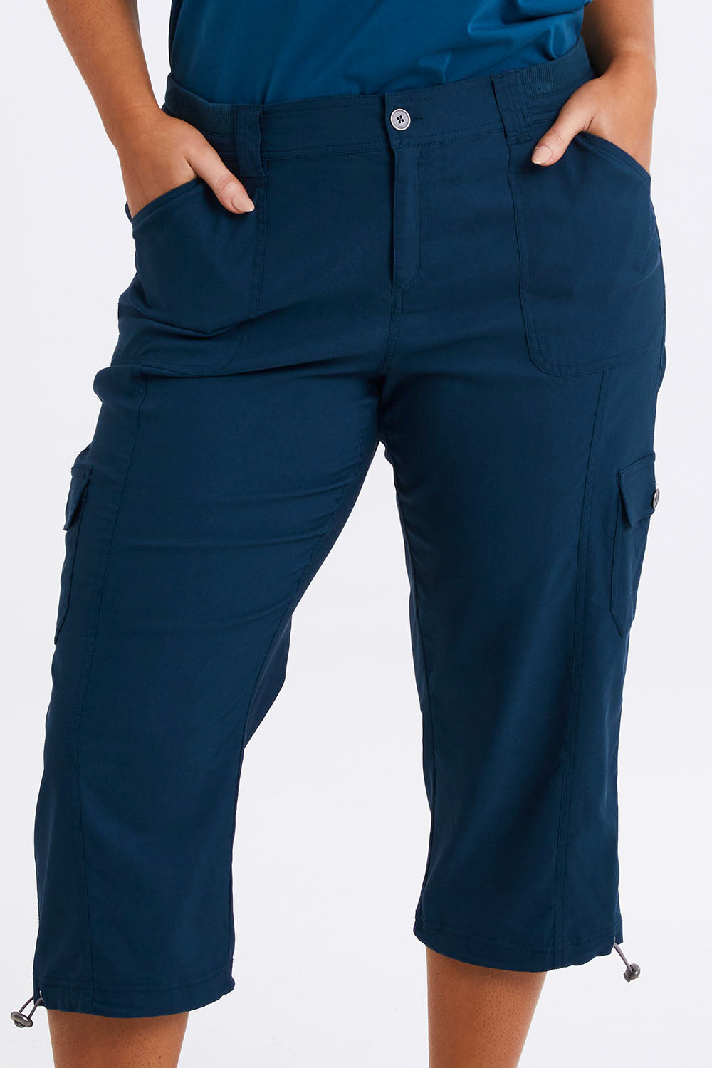 Model Monique wearing size 14 of The Everyday Cropped Cargo Pant in colour Petrol (Blue), from the front, cropped image