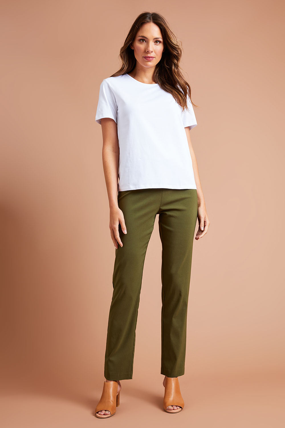 Model Madeline wearing size 10 of The Contour Full Length Pant in colour Olive (Green), from the front, showing the whole outfit