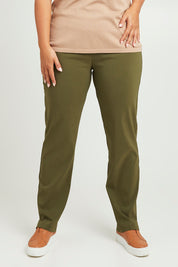 Model Monique wearing size 14 of The Contour Full Length Pant in colour Olive (Green), from the front, cropped image