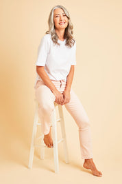 Model Luisa wearing size 10 of The Stretch Coloured Denim Jean in colour Fairyfloss (Pink), from the front, showing the whole outfit