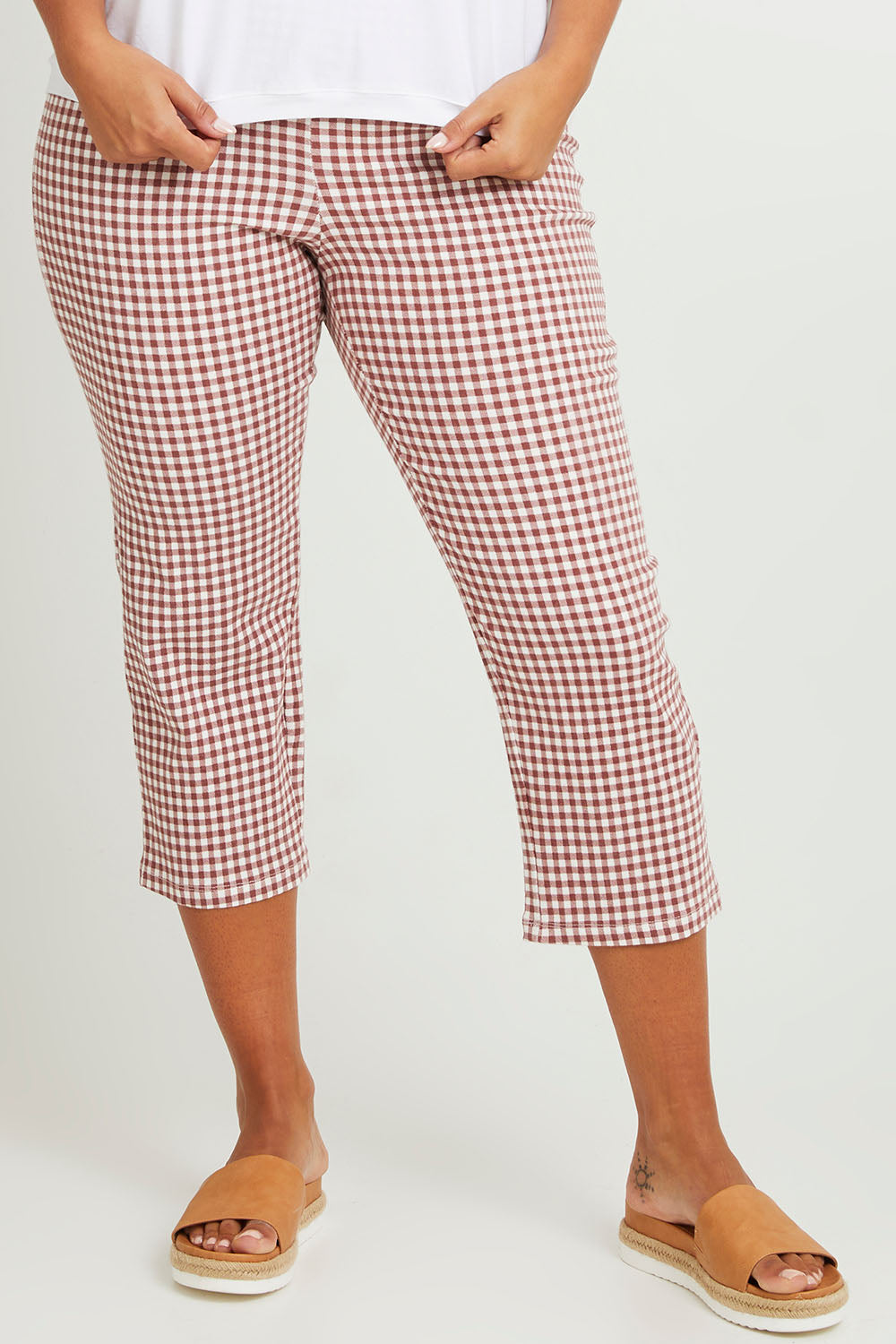Model Monique wearing size 14 of The Check Pull On Pant in colour Dustyrose (Pink), from the front, cropped image
