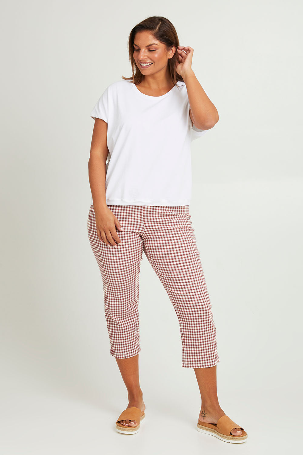 Model Monique wearing size 14 of The Check Pull On Pant in colour Dustyrose (Pink), from the front, showing the whole outfit