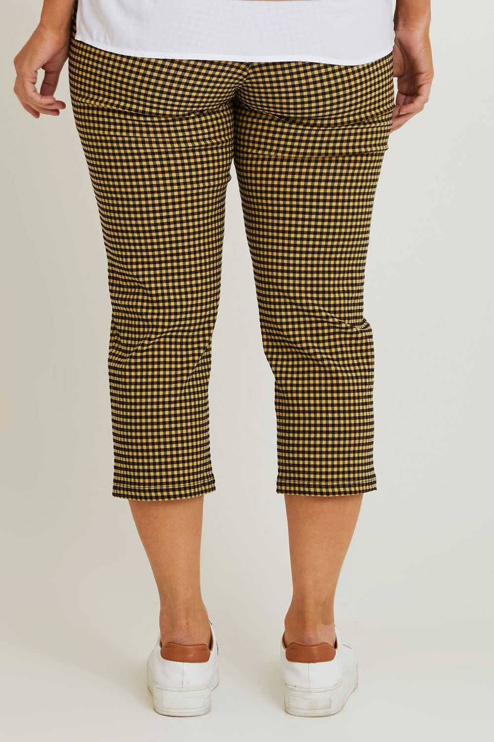Model Laura wearing size 14 of The Check Pull On Pant in colour Navytan (Blue), from the back