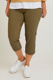 Model Laura wearing size 14 of The Check Pull On Pant in colour Navytan (Blue), from the front, cropped image
