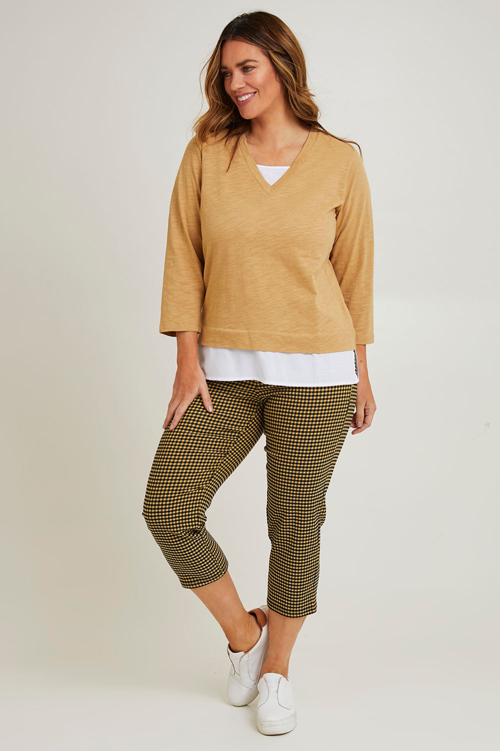Model Laura wearing size 14 of The Check Pull On Pant in colour Navytan (Blue), from the front, showing the whole outfit