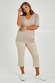 Model Monique wearing size 14 of The Check Pull On Pant in colour Taupewhite, from the front, showing the whole outfit