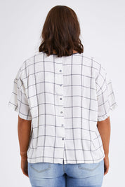 Model Monique wearing size 14 of The Keepers Relax Fit Top in colour Ivorygrey (White), from the back