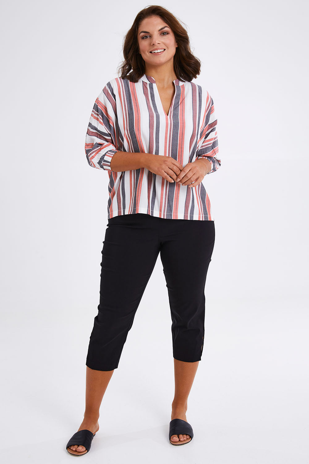 Model Monique wearing size 14 of The Nehru Collar Easy Wear Top in colour Multistrip (Black), from the front, showing the whole outfit