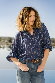 Model Emma wearing size 10 of The Keepers Batwing Shirt in colour Navyfloral (Blue), from the front, showing the whole outfit