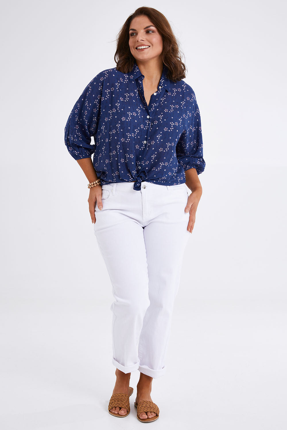 Model Monique wearing size 14 of The Keepers Batwing Shirt in colour Navyfloral (Blue), from the front, showing the whole outfit