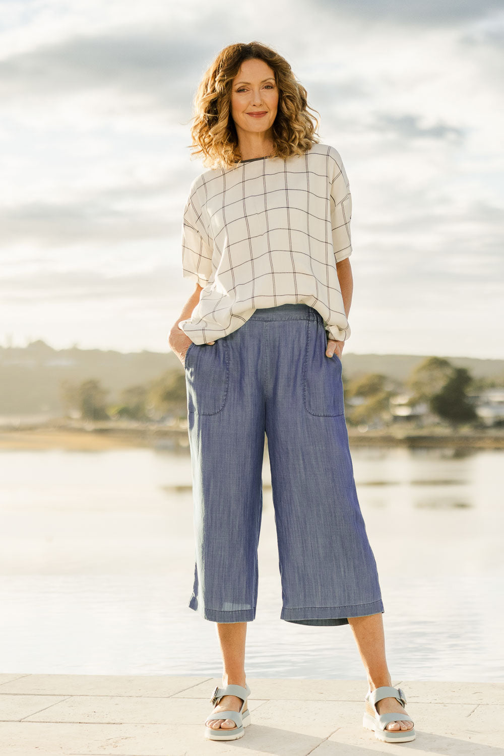 Model Emma wearing size 10 of The Chambray Pull On Cullotes in colour Bluedenim (Blue), from the front, showing the whole outfit