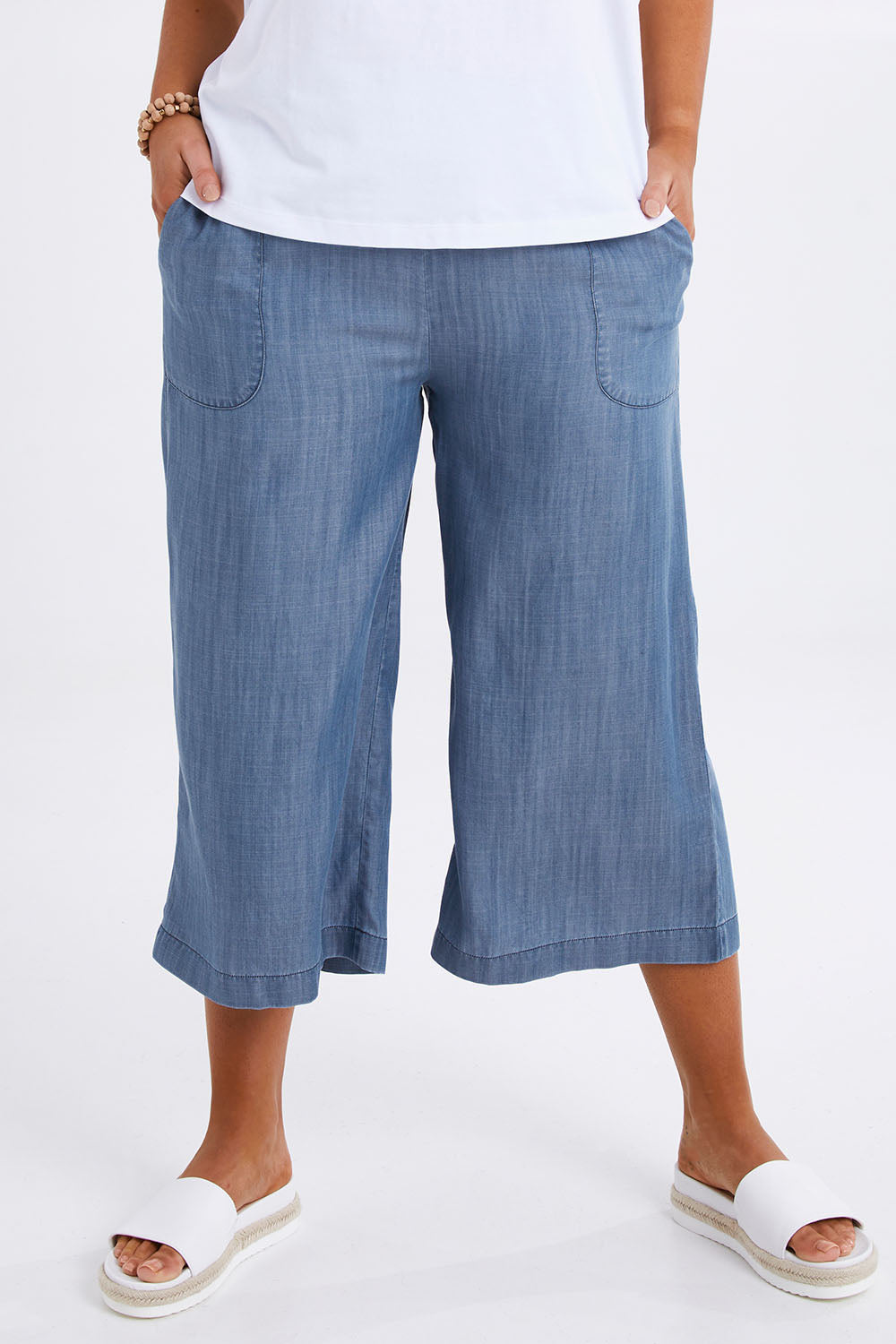 Model Monique wearing size 14 of The Chambray Pull On Cullotes in colour Bluedenim (Blue), from the front, cropped image