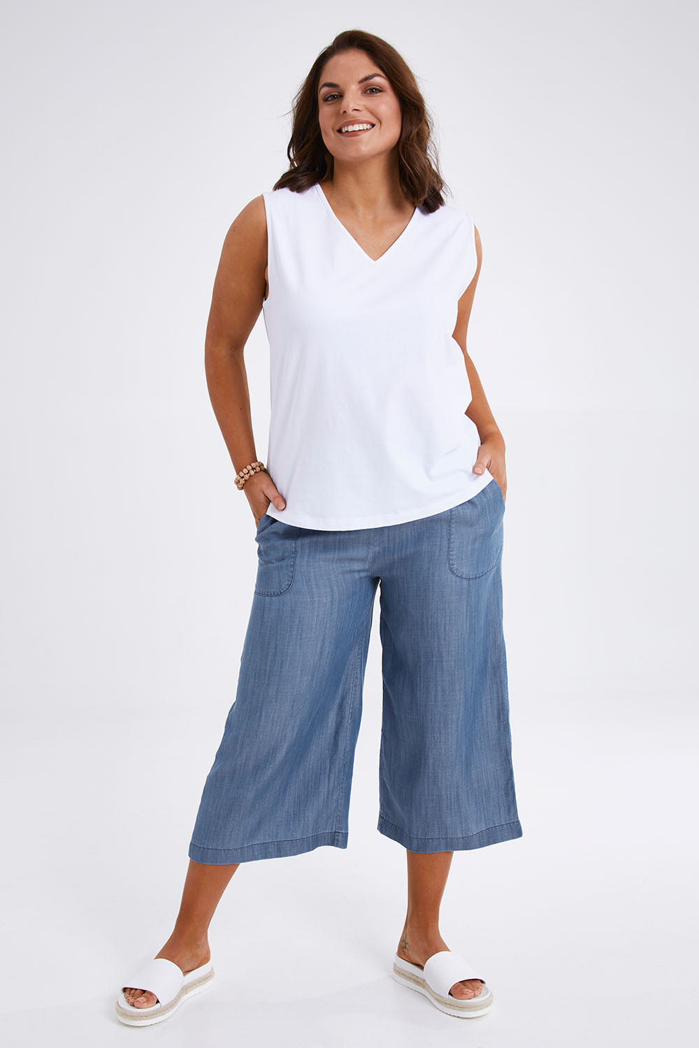 Model Monique wearing size 14 of The Chambray Pull On Cullotes in colour Bluedenim (Blue), from the front, showing the whole outfit