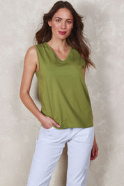 Model Madeline wearing size 10 of The Keepers Cotton Tank in colour Avocado (Green), from the front, showing the whole outfit