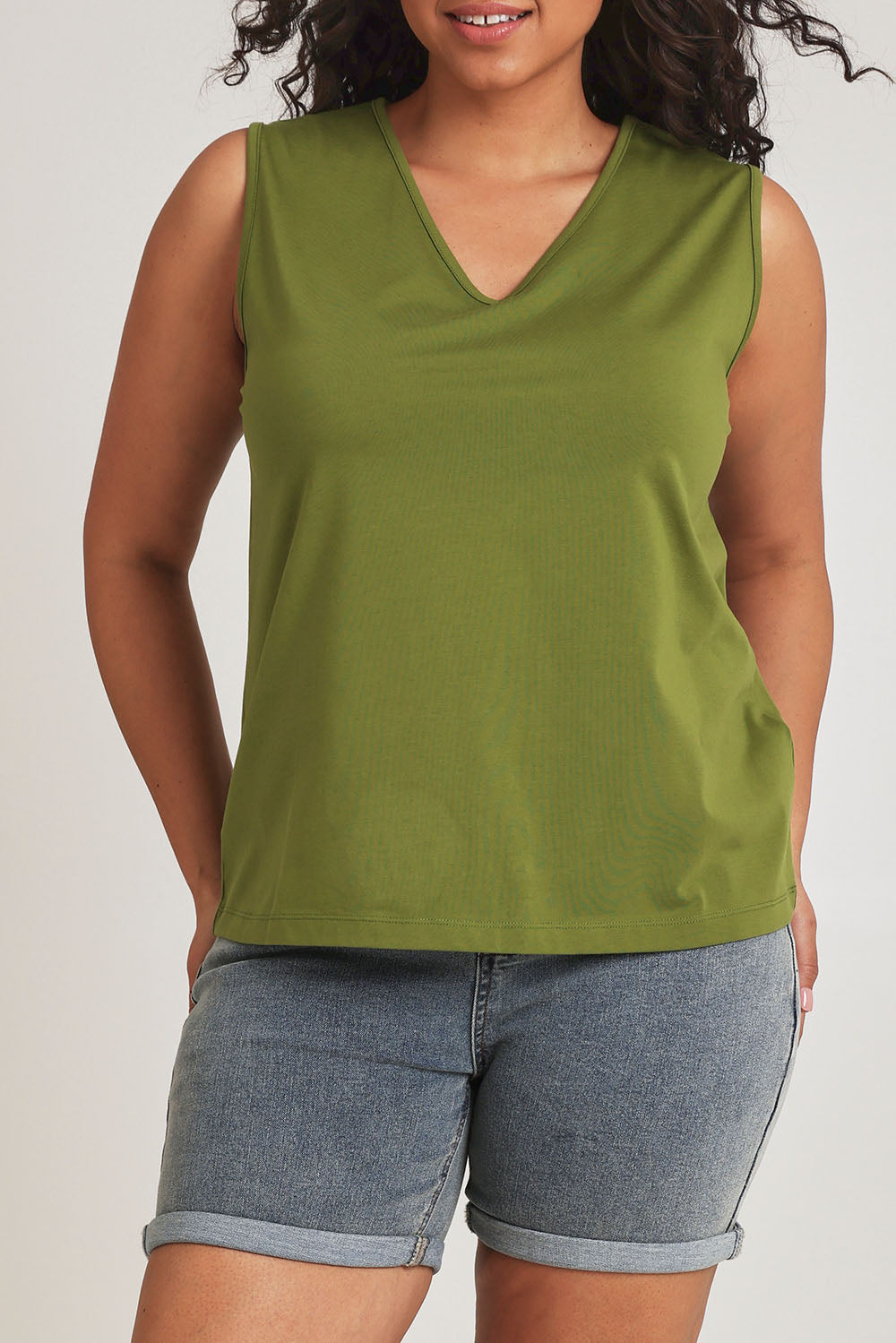 Model Terri-Leigh wearing size 14 of The Keepers Cotton Tank in colour Avocado (Green), from the front, cropped image