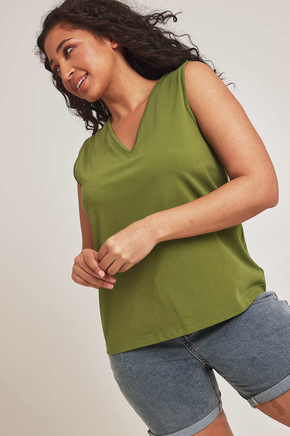 Model Terri-Leigh wearing size 14 of The Keepers Cotton Tank in colour Avocado (Green), from the front, cropped image
