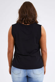 Model Monique wearing size 14 of The Keepers Cotton Tank in colour Black (Black), from the back
