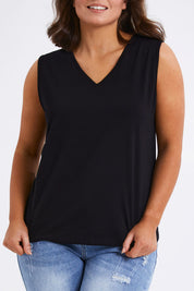 Model Monique wearing size 14 of The Keepers Cotton Tank in colour Black (Black), from the front, cropped image