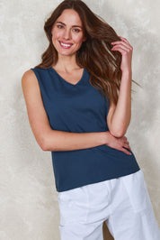 Model Madeline wearing size 10 of The Keepers Cotton Tank in colour Frenchblue (Blue), from the front, showing the whole outfit