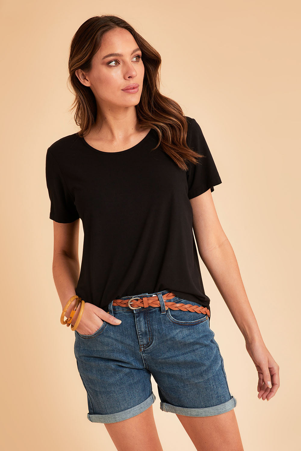 Model Madeline wearing size 10 of The Bamboo Curved Hem Tee in colour Black (Black), from the front, showing the whole outfit