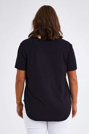 Model Monique wearing size 14 of The Bamboo Curved Hem Tee in colour Black (Black), from the back