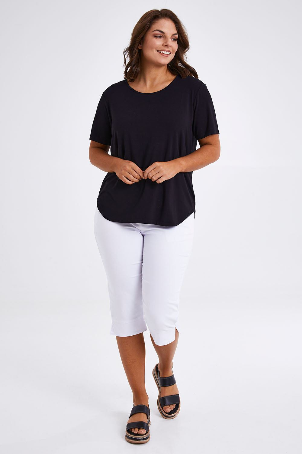 Model Monique wearing size 14 of The Bamboo Curved Hem Tee in colour Black (Black), from the front, showing the whole outfit