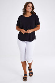 Model Monique wearing size 14 of The Bamboo Curved Hem Tee in colour Black (Black), from the front, showing the whole outfit