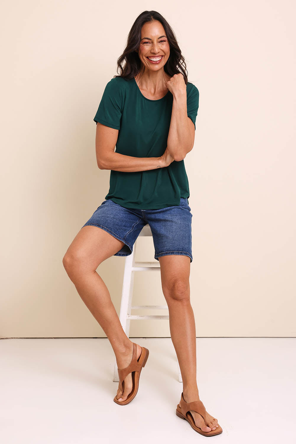 Model Amandam wearing size 10 of the The Bamboo Curved Hem Tee – Forest in colour Forest, from the front
