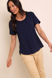 Model Amandam wearing size 10 of the The Bamboo Curved Hem Tee – Navy in colour Navy, from an angle