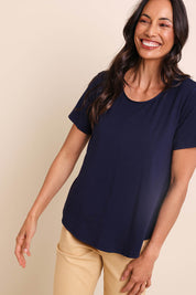 Model Amandam wearing size 10 of the The Bamboo Curved Hem Tee – Navy in colour Navy, in a cropped view