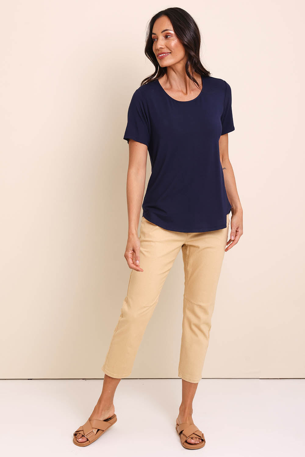 Model Amandam wearing size 10 of the The Bamboo Curved Hem Tee – Navy in colour Navy, from the front