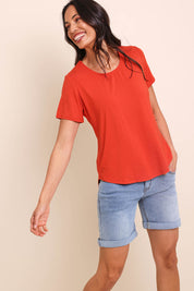Model Amandam wearing size 10 of the The Bamboo Curved Hem Tee – Sunset in colour Sunset, from an angle