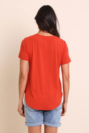 Model Amandam wearing size 10 of the The Bamboo Curved Hem Tee – Sunset in colour Sunset, from the back